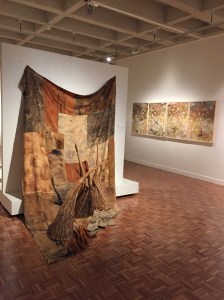 Liz Mahood described making the four panelled artwork 'The Invisible that Is', depicted in the background, whilst at the artist camp at Bimblebox. After 3 days at camp, her mind was finally free of everyday concerns and her eyes began to see the landscape around her, and the work 'made itself'. Jill Sampson's wonderful installation in the foreground echoes the colours and textures of Liz's paintings and, of course, the landscape of Bimblebox itself.